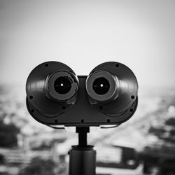 Close-up of coin-operated binoculars against sky