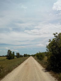 Empty road against cloudy sky