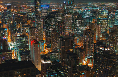 High angle view of illuminated buildings in city at night