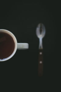 Close-up of coffee cup against black background