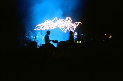 Silhouette people with light painting at night