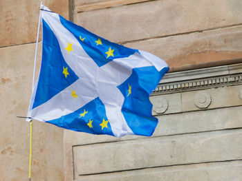 Low angle view of scottish flag against wall