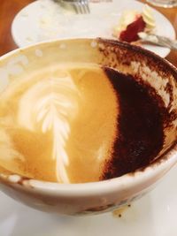 Close-up of cappuccino served on table