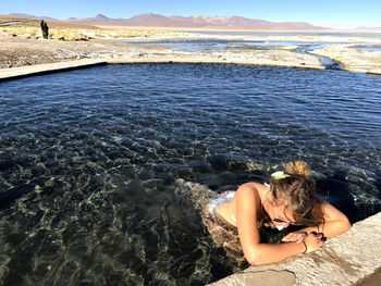 High angle view of young woman in pond