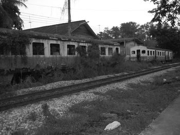 Houses by road against sky
