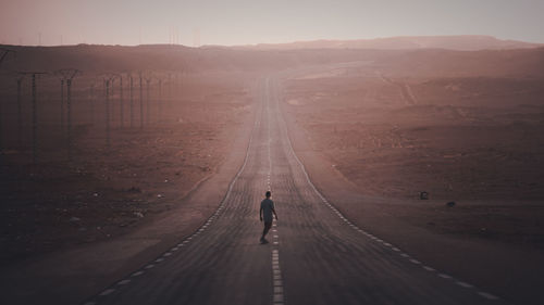 Rear view of man walking on mountain