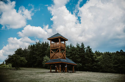 Traditional windmill on field against sky