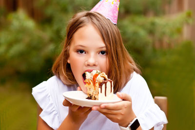 Portrait of girl eating cake