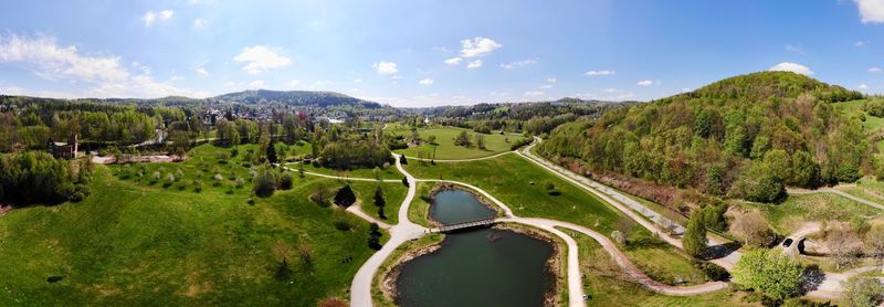 Panoramic view of green landscape against sky