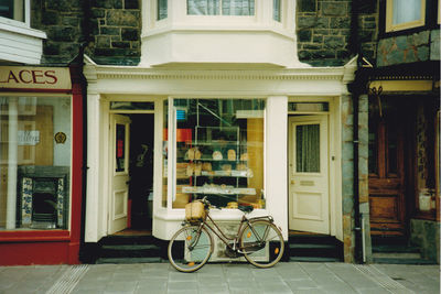 Bicycle against building in city