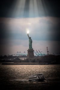 Statue of liberty against cloudy sky