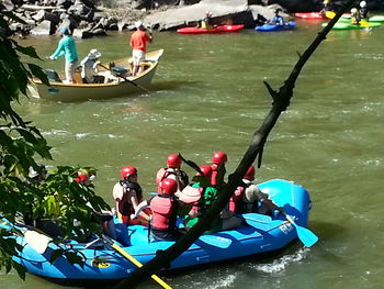 High angle view of people sitting on boat in river