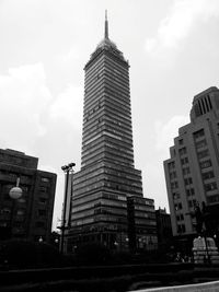 Low angle view of buildings against cloudy sky