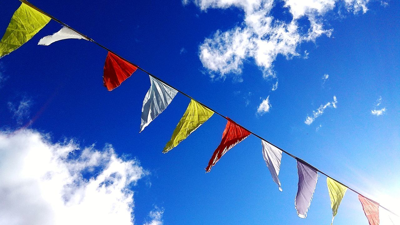 LOW ANGLE VIEW OF FLAGS AGAINST SKY