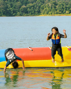 Full length of young woman in boat on lake