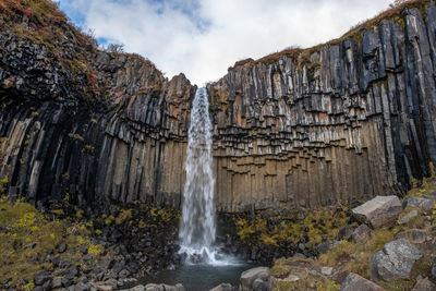 Low angle view of svartifoss in iceland