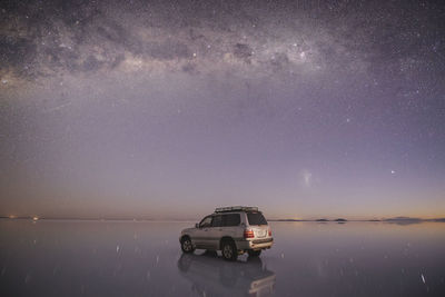 Car over the water under the stars