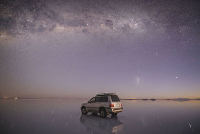 Car on land against sky at night