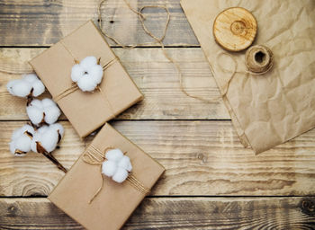 Boxes packed in kraft paper, twine on a wooden background.environmentally friendly material.