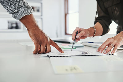 Midsection of business colleagues working at office