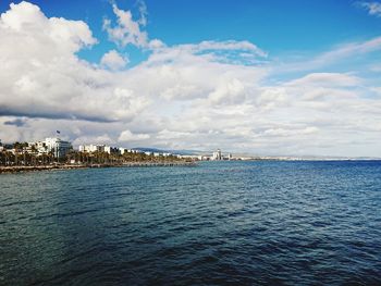 Scenic view of sea and buildings against sky