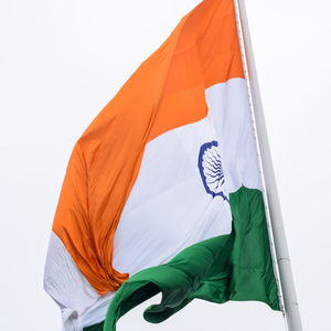 India flag flying high at connaught place with pride in blue sky, india flag fluttering, indian flag