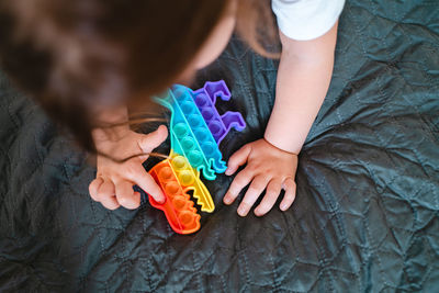 High angle view of girl playing with toy