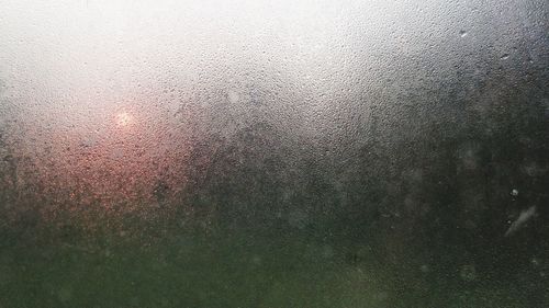 Full frame shot of raindrops on window