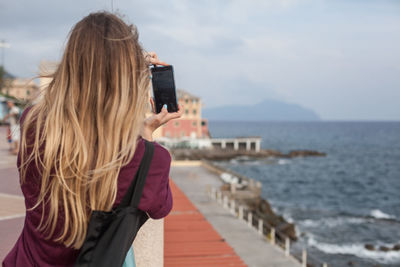 Rear view of woman looking at sea