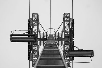 Low angle view of crane against clear sky