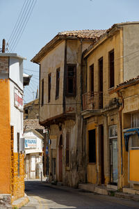 Street amidst buildings against sky in city