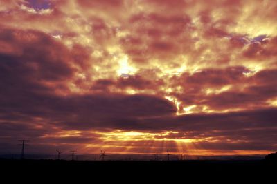 Silhouette of landscape against cloudy sky