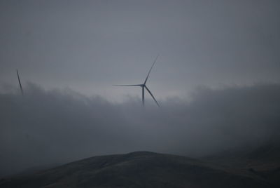 Low angle view of windmill against sky