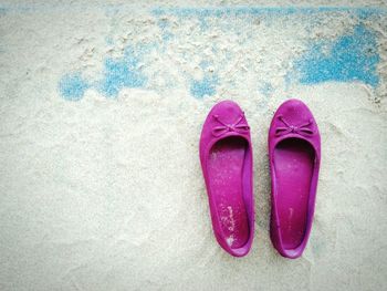 High angle view of purple shoes on sand