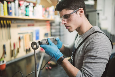 Young mechanic working in repair garage