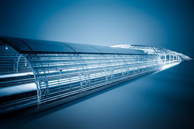 Aerial view of illuminated bridge against clear blue sky