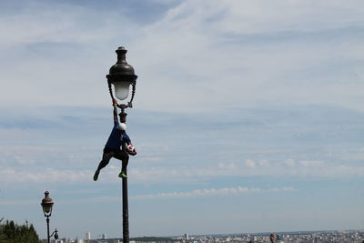 Statue of street light against sky