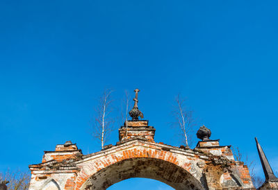 Low angle view of historical building against blue sky