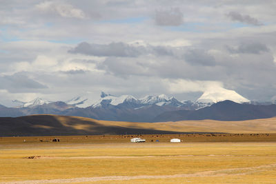 Scenic view of landscape and mountains against sky