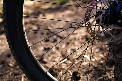 Close-up of bicycle wheel on field