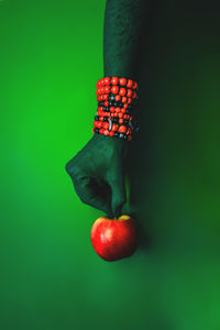 Close-up of red berries over green background