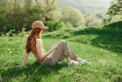 Young woman sitting on field