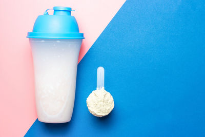 Close-up of drink in glass bottle against blue background