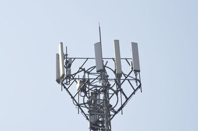 Low angle view of communications tower against sky