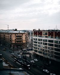 High angle view of traffic on road by buildings against sky