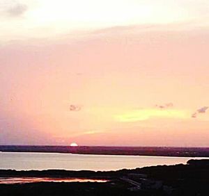 Scenic view of sea against romantic sky at sunset