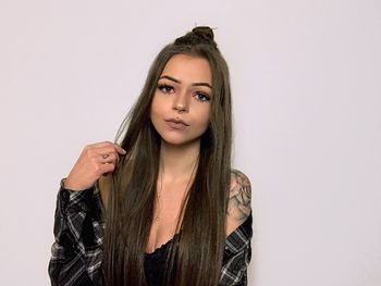 Portrait of beautiful young woman against white background