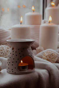 Close-up of illuminated candles on table