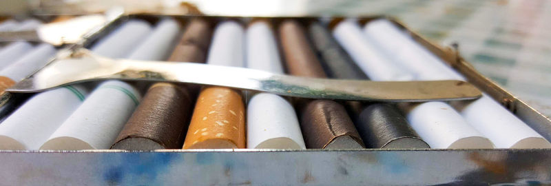 Close-up of cigarettes in box on table