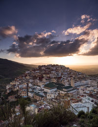 High angle shot of townscape against sky at sunset